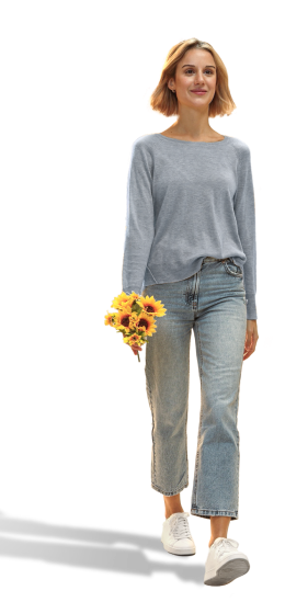 Photo image of an adult female walking with sunflowers in hand